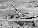 A camouflaged gun entrenched in the sand and covered with netting on the beaches of Nieuport, 1916.