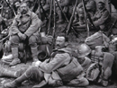 A weary group of older reservists or territorials takes a brief rest while on the march. (1916)