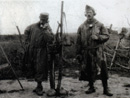 A group of artillery observers wearing camouflage frocks.