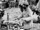 A group of territorials prepares barbed-wire bundles to be carried up to the front.