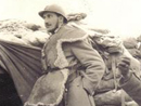 A somewhat posed shot in an advanced post, with soldiers wearing winter gear including sheepskins and trench boots.