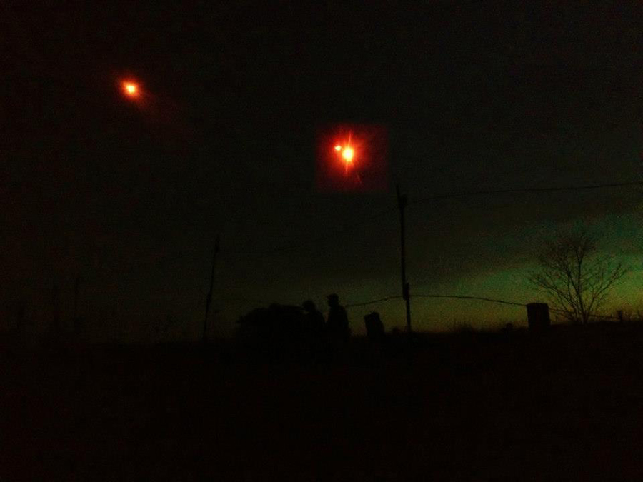 Flares descend in the night sky as soldiers man their post, April 2014.