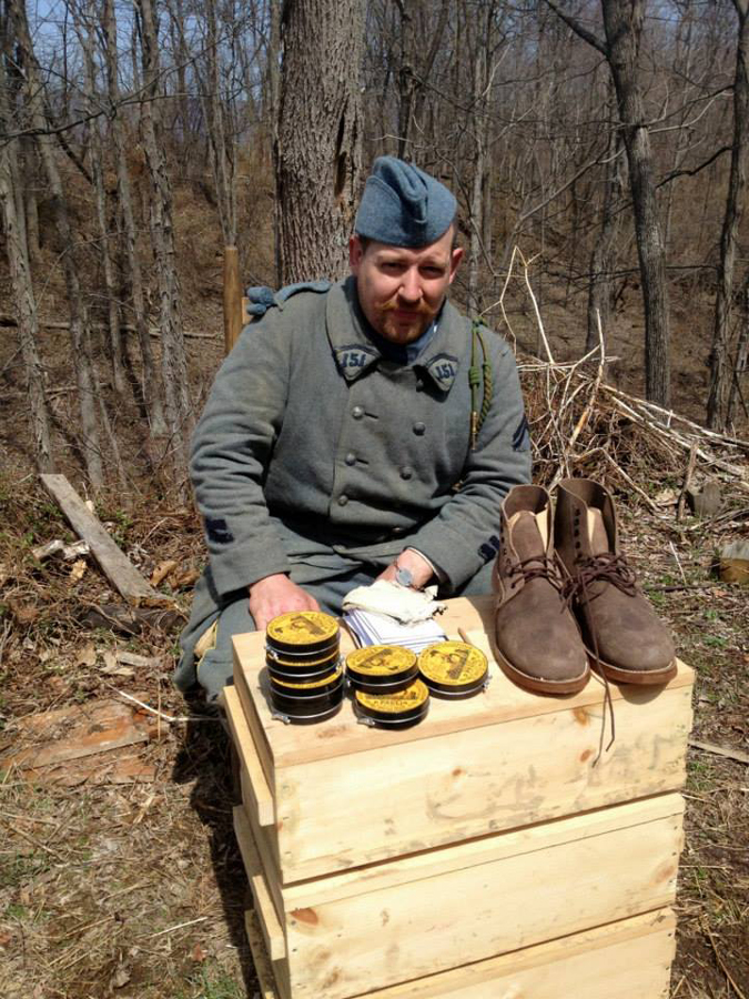 Cpl. Picard beside a distribution of shoe polish and boots, April 2014.