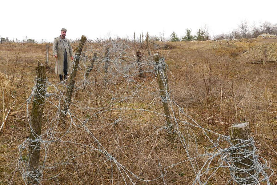 Sgt. Contamine stands beside a repaired belt of barbed-wire, Work Weekend, October 2014.