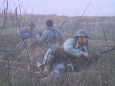 Sgt. Contamine takes cover during an attack in no-man's-land, April 2004.