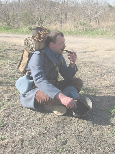 Sdt. Brun smokes a pipe after morning formation, April 2005.