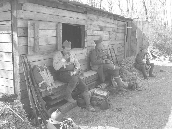 Sdts. Fagot, Hauser and Fleury eating their morning mess--beef and vegetable stew, bread and coffee. April 2005