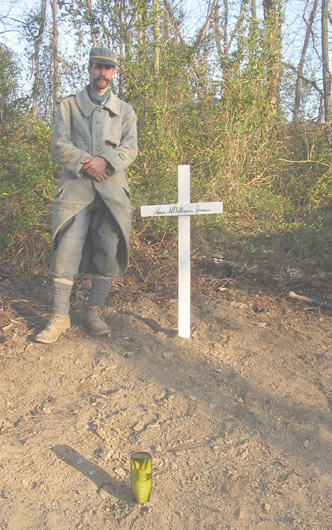 Sgt. Contamine stands beside the unit's newly erected memorial to the French soldiers of the Great War. The cross is inscribed: 
