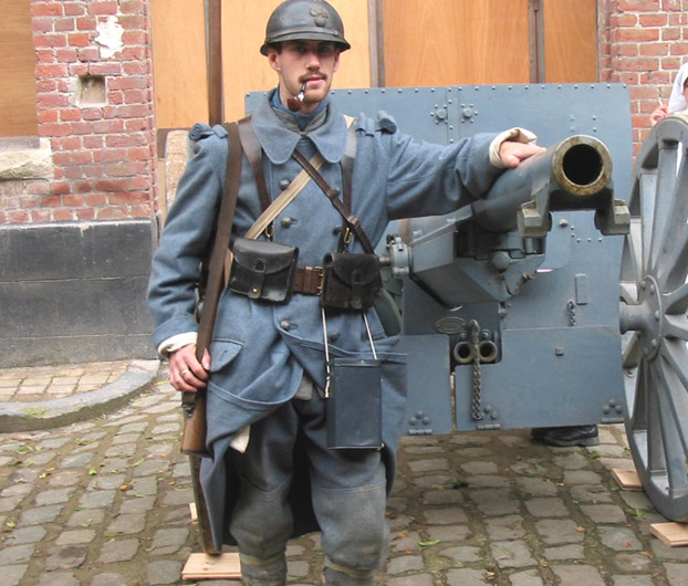 Jean Contamine stands next to one of the famous 75mm canons in a living history at Fort Seclin, France, October 2004.