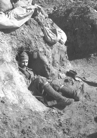 Sgt. Contamine in a small shelter dug into trench wall - Newport News, VA, March 2005 
