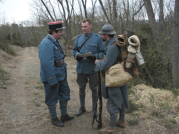 Sgt. Contamine reporting the status of the unit to Capt. William and Lt. Hauser from Battalion staff before heading up to the line, April 2006.