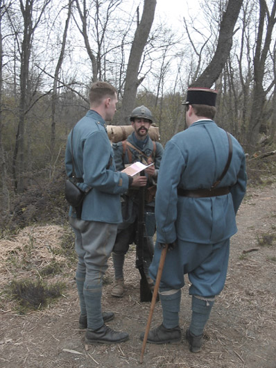 Sgt. Contamine reporting the status of the unit to Capt. William and Lt. Hauser from Battalion staff before heading up to the line, April 2006.