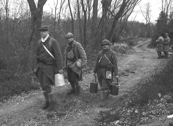 Cpl. Picard leads a water chore with Sdts. Desjardins and Martin, April 2006.