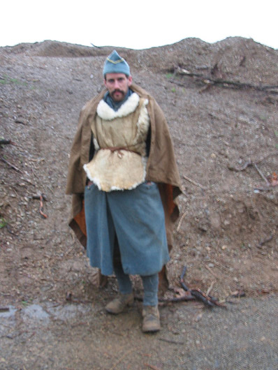 Sgt. Jean Contamine tries to stay warm and dry after a miserable wet night, April 2006.