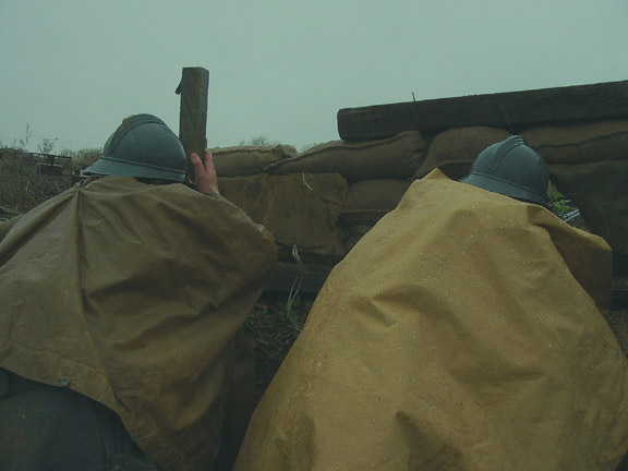 Cpl. Picard searches for a target through a periscope as Sdt. Martin at a loophole acts as the shooter, April 2006.