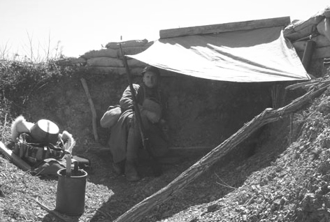 Sdt. Bouchez shelters from the sun, April 2007.