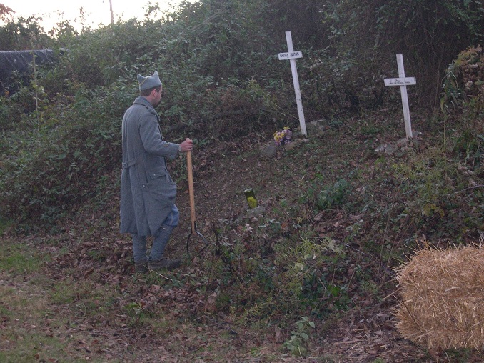 Sgt. Contamine cleans up our scared grounds: Justin Hoover's grave and the unit memorial to the French soldiers of the Great War, November 2011.