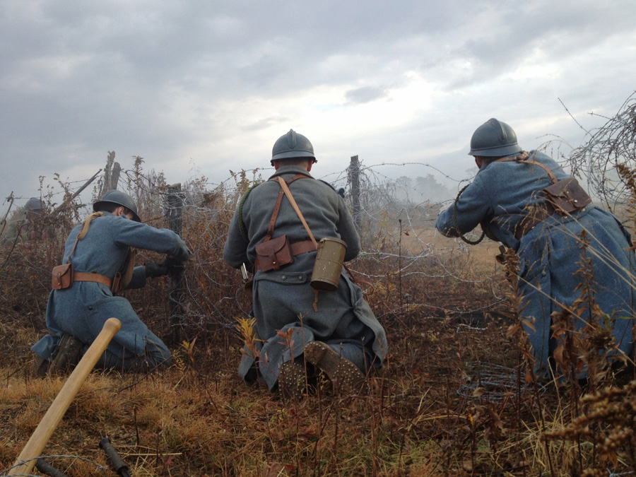 Repairing wire under the cover of a smoke screen. Newville, November 2013.