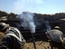 A Canadian mortar team firing high-explosive rounds on the German positions, November 2014.