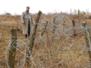 Sgt. Contamine stands beside a repaired belt of barbed-wire, Work Weekend, October 2014.