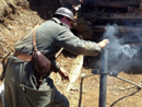 Sgt. Contamine takes a turn dropping a mortar round down the tube, April 2014.