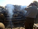 A Canadian mortar team firing high-explosive rounds on the German positions, November 2014. 