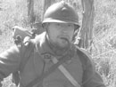 Cpl. Picard takes a moment to get off his feet and have a pipe after morning formation, April 2005.