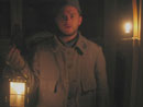 Sdt. Bracken holds a squad lantern in the bunker as he warms up from the cold, April 2005.