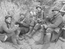 Sdts. Bright and Brun sit down with Sgt. Contamine and Cpl. Picard for supper in the first line trench, November 2005.