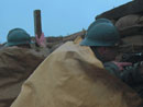 Cpl. Picard and Sdt. Martin searching for targets under the rain, April 2006.