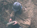 Sgt. Contamine cleans the mud and water from the mirrors of a periscope, April 2006