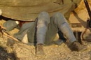 One man rests as another watches the enemy at the observation post, April 2007.