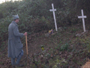 Sgt. Contamine cleans up our scared grounds: Justin Hoover's grave and the unit memorial to the French soldiers of the Great War, November 2011.