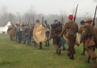 The French company marches through a sudden downpour. Newville, April 2013.