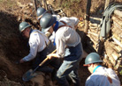 Members of the 151 repairing a trench wall. Newville, November 2013.