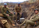 Members of the Red Hands preparing a meal in the second line trenches. Newville, November 2013.