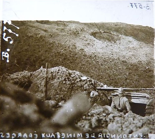 A sentry looks out over the devastated hills of Les Éparges, pocked with shell-holes and massive mine craters, 1916.