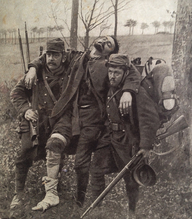 A wounded French soldier is helped to the rear by some comrades, January 1915.