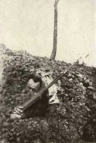 A dead French soldier half-buried in a bombardment.