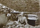 A sentry looks out over the devastated hills of Les Éparges, pocked with shell-holes and massive mine craters, 1916.