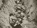 German troops caught by an enfilading machine-gun fire lay piled up in a communication trench.